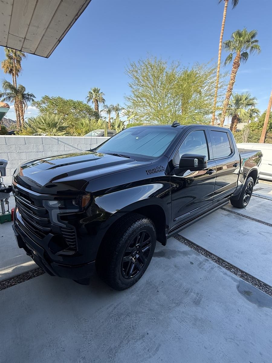 Black Chevrolet Silverado High Country with a deep, glossy shine after a full detail